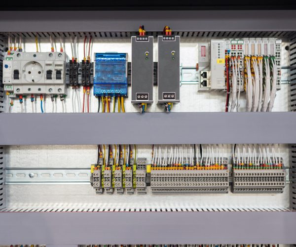 Making an electricity panel board - the inside of the panel - slots and wires. Mid shot